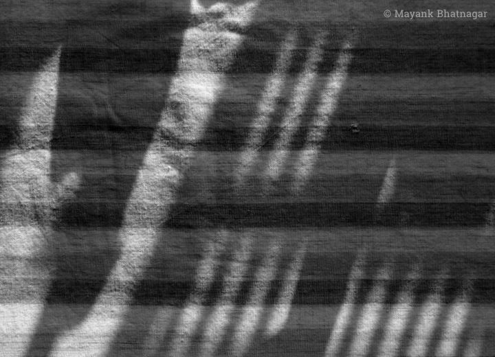 Angular streaks of light from a window falling on a striped table cloth