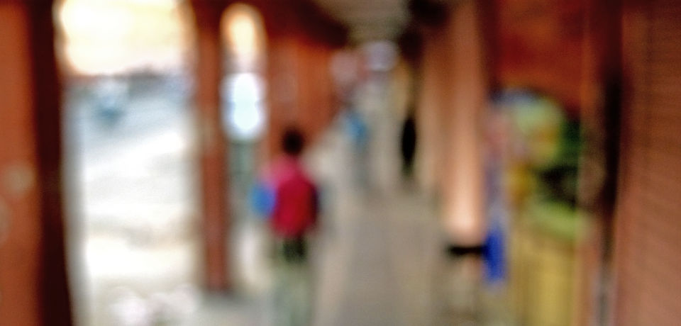 Blurred photograph of a people walking in a varendah or corridor at Johri Bazaar, Jaipur